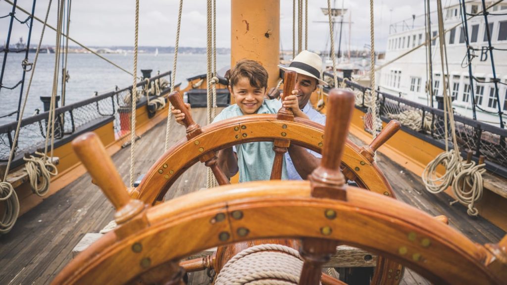 Father and son playing on boats at the Maritime Museum in San Diego (Photo: Visit California/David Collier)