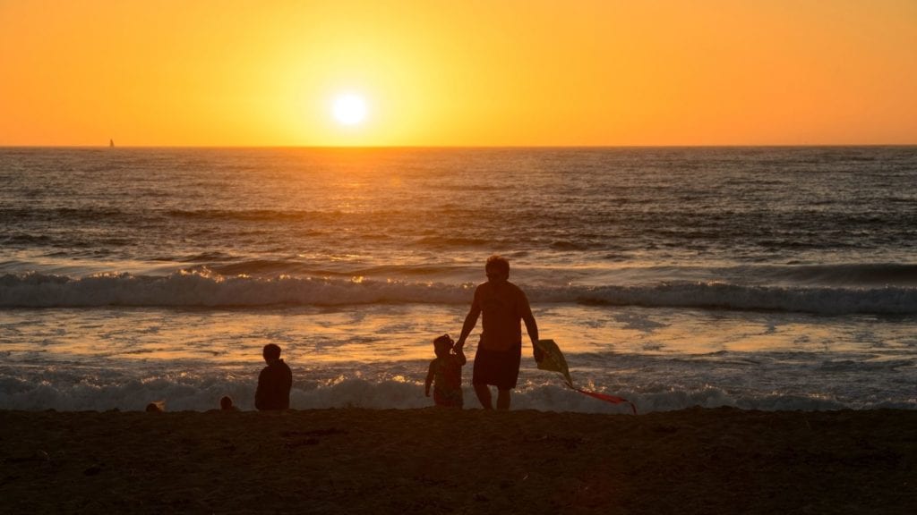 family on beach at sunset at Del Monte Beach in Monterey