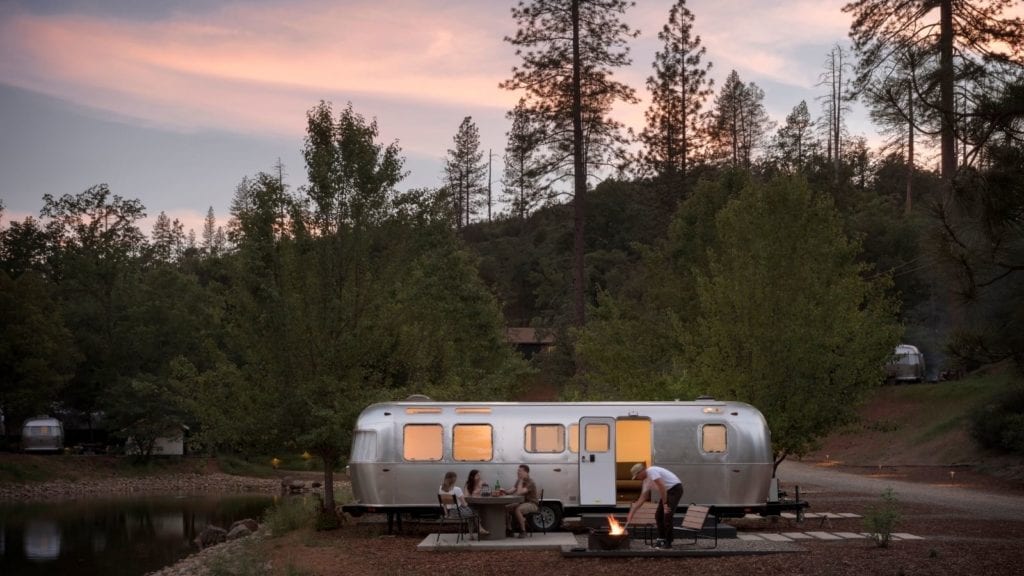 view of Airstream trailer and campers by fire at AutoCamp Yosemite: hotels near Yosemite