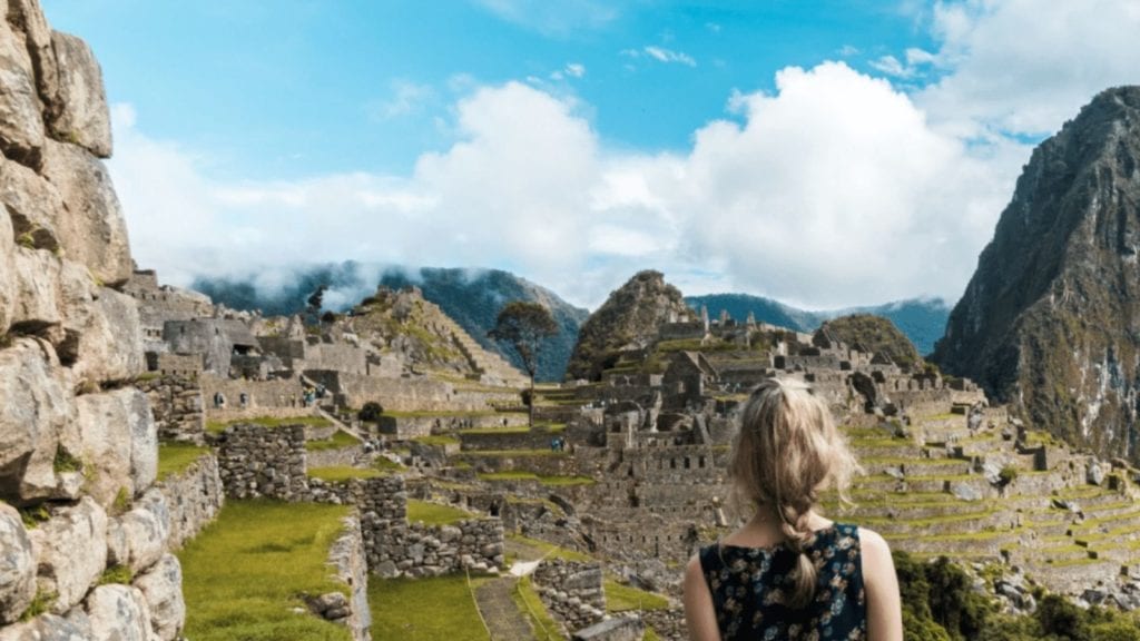 Young girl views Machu Picchu from a distance (Photo: Willian Justen on Unsplash)