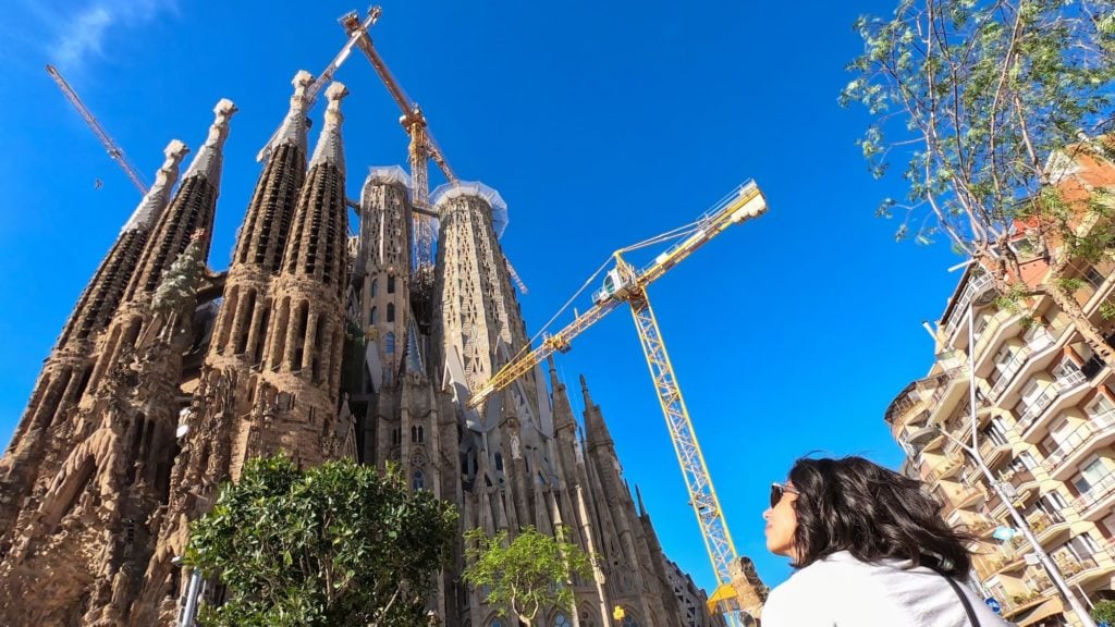 Person looking up at Sagrada Familia in Barcelona. Sagrada Familia is one of the top Europe tourist attractions