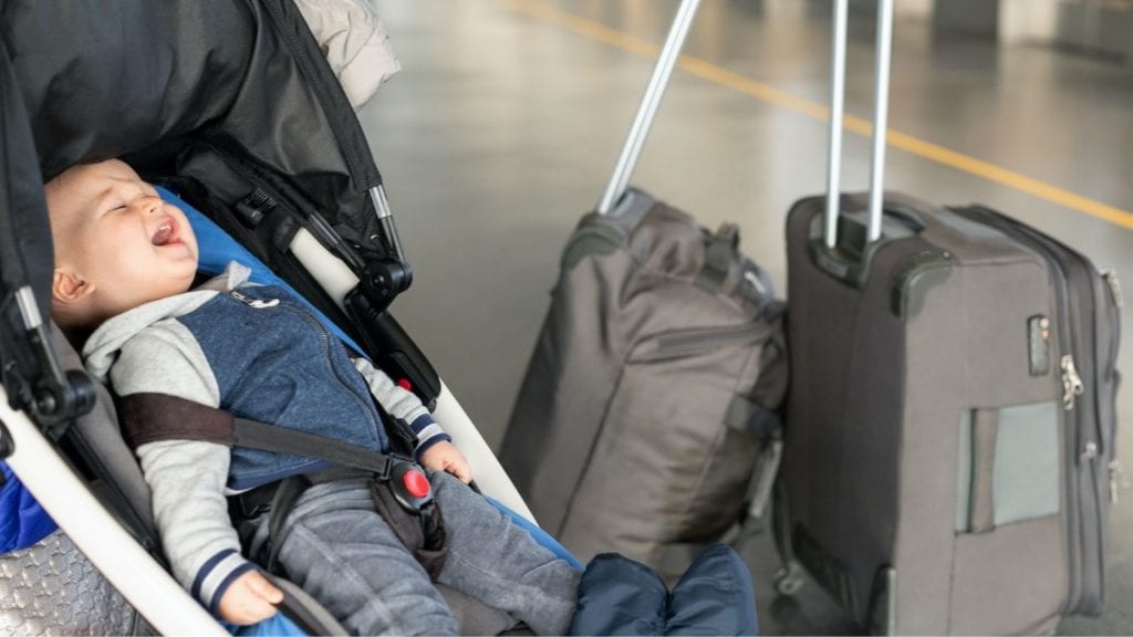 Child in carseat at airport (Photo: Shutterstock)