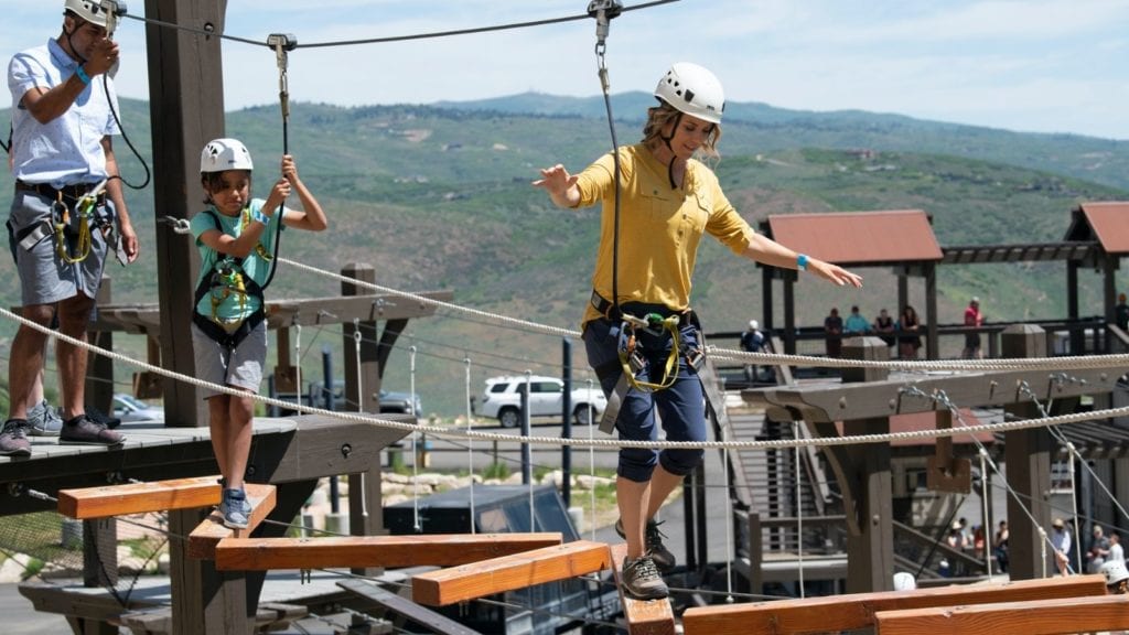 Mom walking across a bridge on the ropes course at Utah Olympic Park (Photo: Park City Chamber)