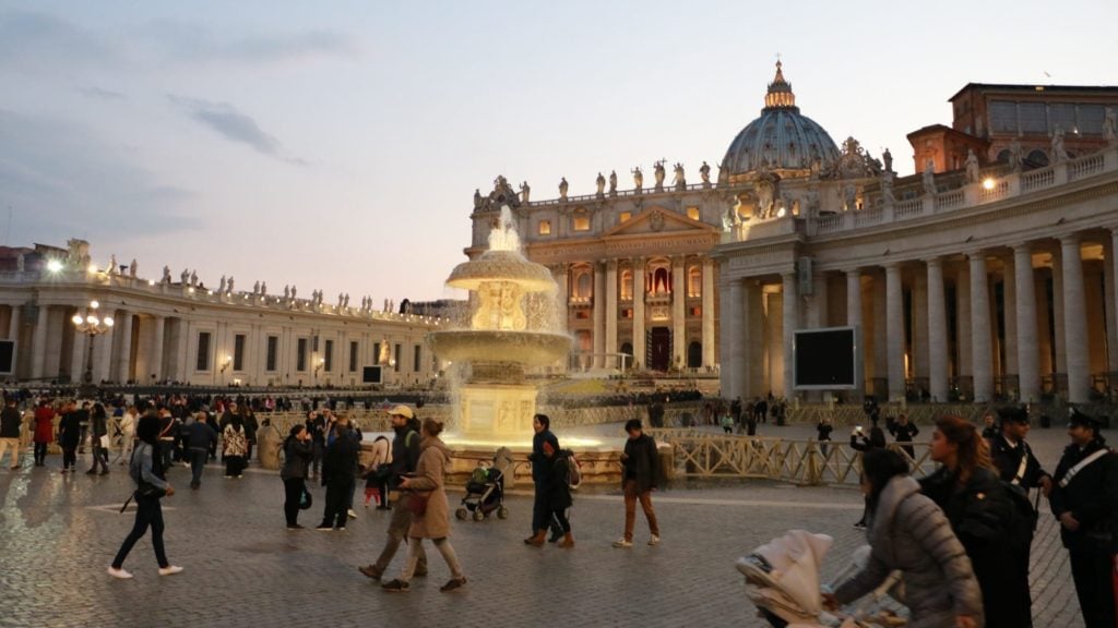 Vatican City at sunset with people in foreground. Vatican City in Italy is a top Europe tourist attraction