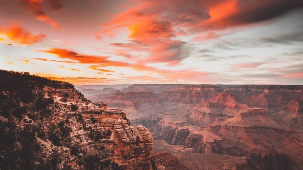 View of the Grand Canyon with pink clouds at sunset. The Grand Canyon is one of the top US tourist attractions