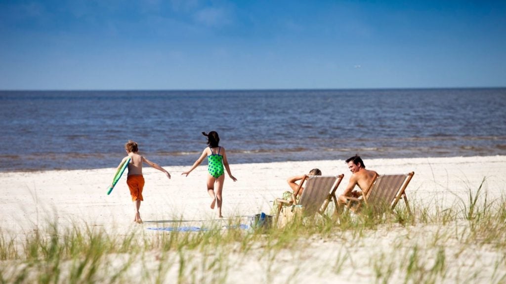 Children running on the beach (Photo: Coastal Mississippi)