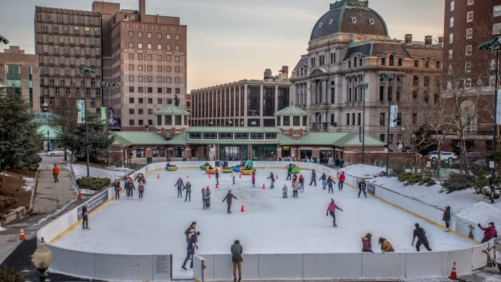 daytime view of Providence Rink outdoor ice skating rink with city buildings in background