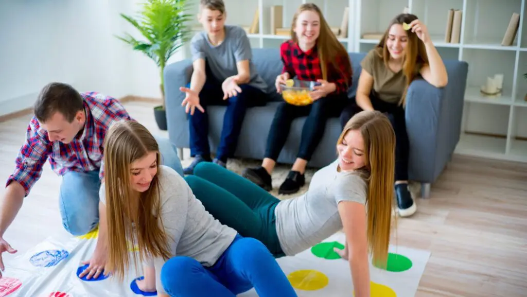 Family playing classic board game Twister (Photo: Elena Nichizhenova/Shutterstock)