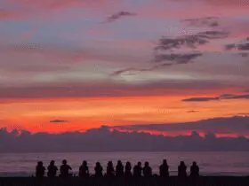 people sitting on sunset beach