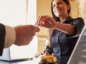 Guest takes room key card at check-in desk of hotel (Photo: Shutterstock)