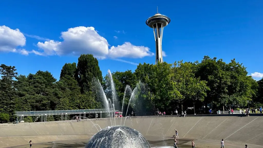 kids playing at a splash pad in Seattle with Space Needle in the background