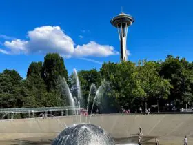 kids playing at a splash pad in Seattle with Space Needle in the background
