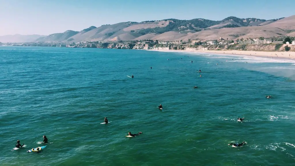 View of Pismo Beach surfers and coastline on a sunny day