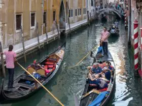Gondolas passing each other in a canal in Venice. Venice is one of the top Europe tourist attractions