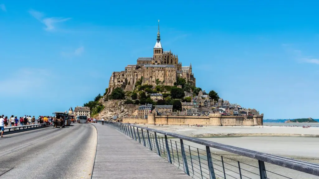 view of Mont Saint-Michel from causeway. Mont Saint-Michel in France is a top Europe tourist attraction