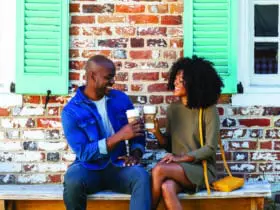 Couple toasting with coffee in Yorktown near Williamsburg