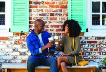 Couple toasting with coffee in Yorktown near Williamsburg