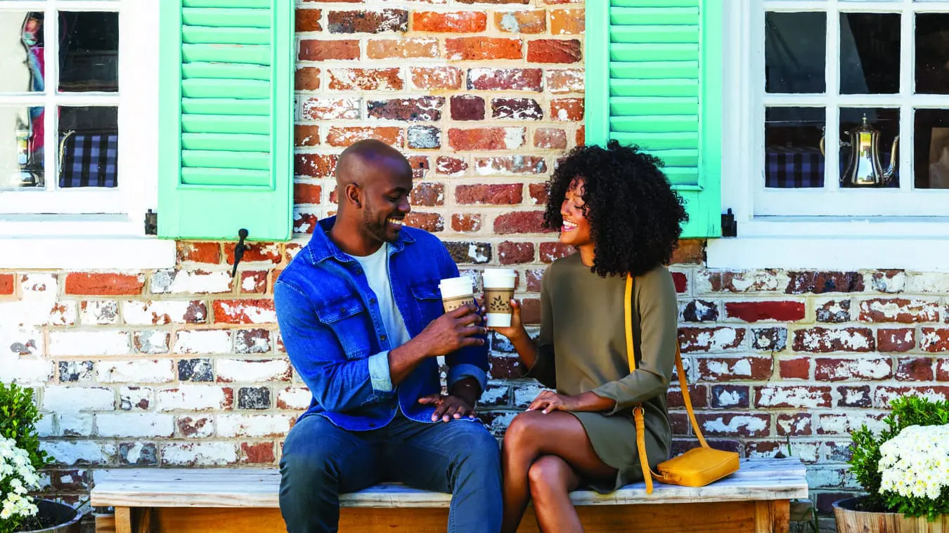 Couple toasting with coffee in Yorktown near Williamsburg