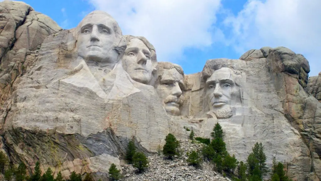 Mount Rushmore and partly cloudy sky.