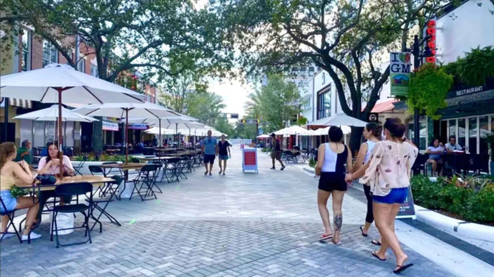 people walking along downtown Clematis Street