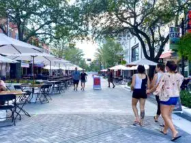 people walking along downtown Clematis Street