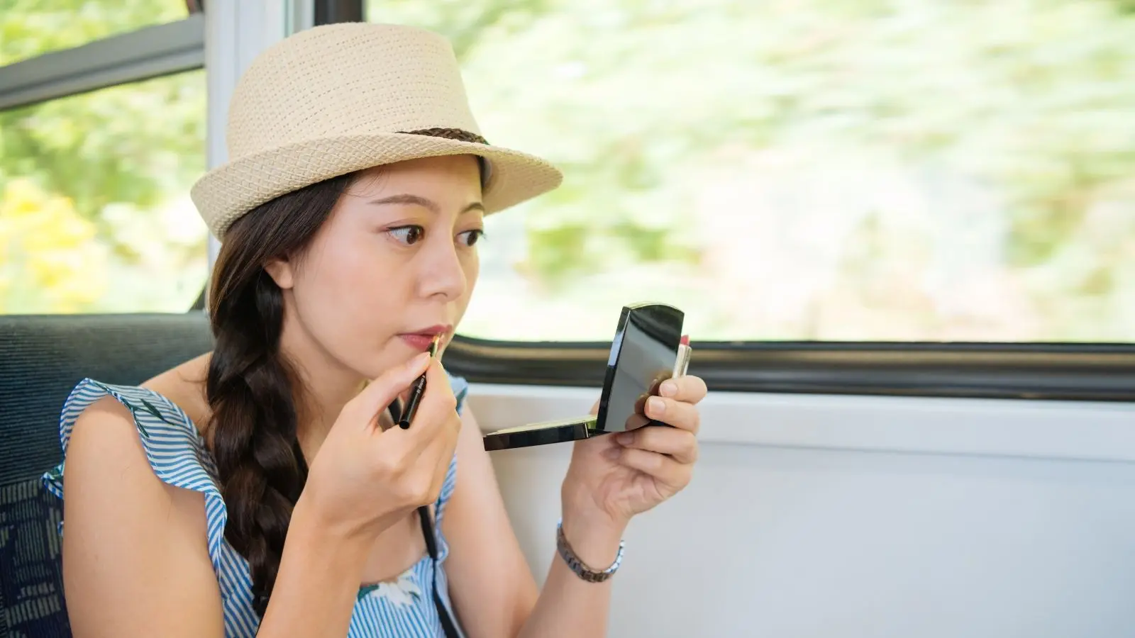 Woman repairing makeup with multi-use beauty products (Photo: Shutterstock)