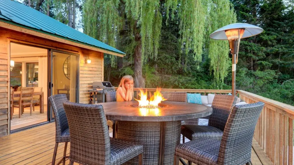 Child enjoying outdoor patio heater on vacation (Photo: Shutterstock)