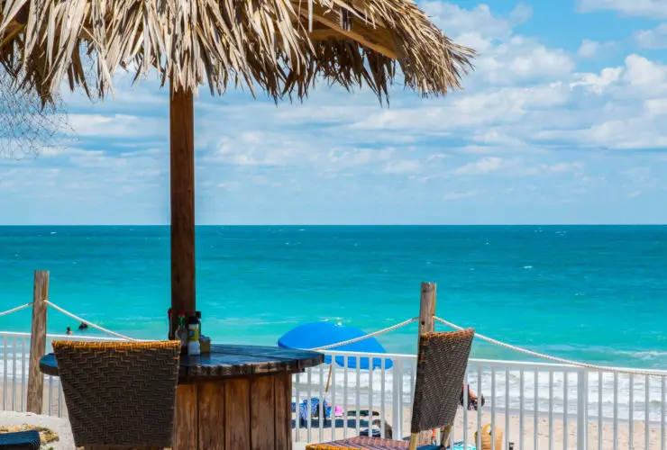 Thatched umbrella and table overlooking the water in Vero Beach Florida