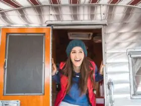 Woman poking her head out of a vintage RV (Photo: @jordvdz via Twenty20)
