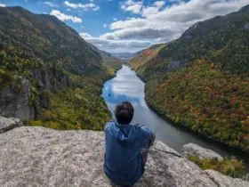 Man sitting on Indian Head Cliff at Adirondack Park, New York (Photo: Shutterstock)