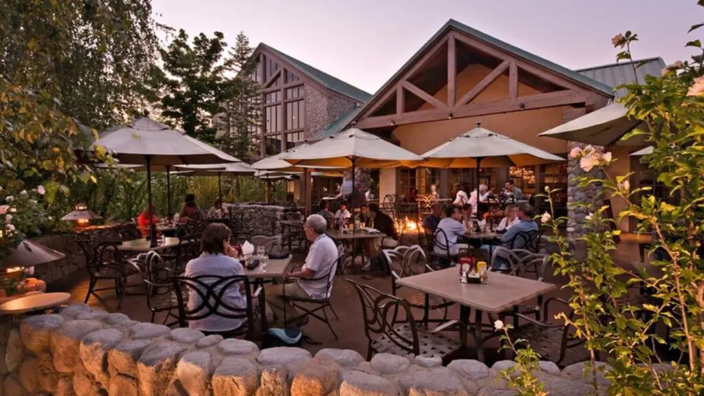people sitting on the patio of Jackalope's Bar and Grill at Tenaya at dusk