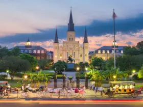 Evening in New Orleans at Jackson Square with illuminated buildings and horses and carriages