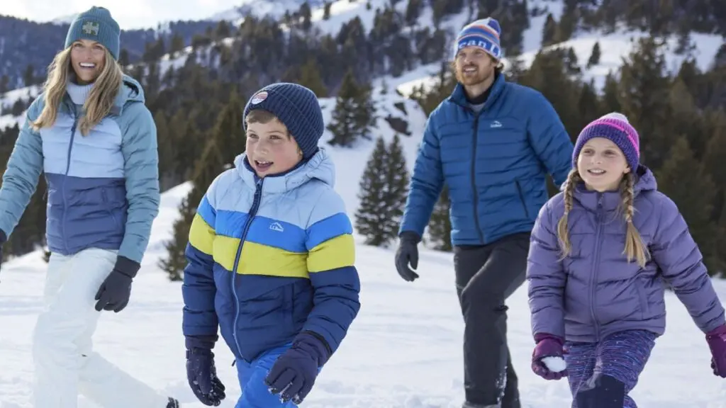 A family in the snow wearing L.L.Bean jackets