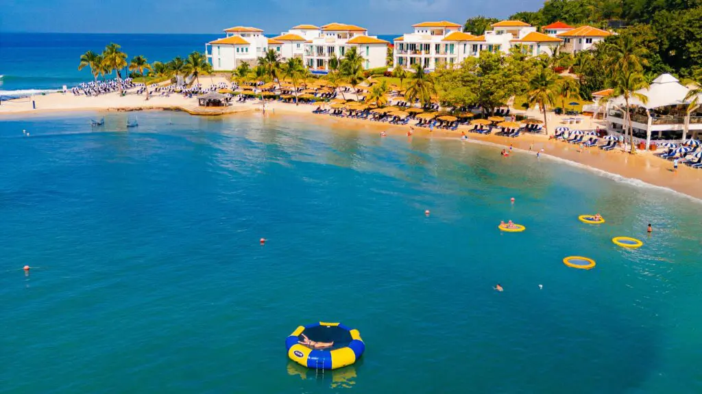 A view of the beach area with people in the water at Windjammer Landing Resort