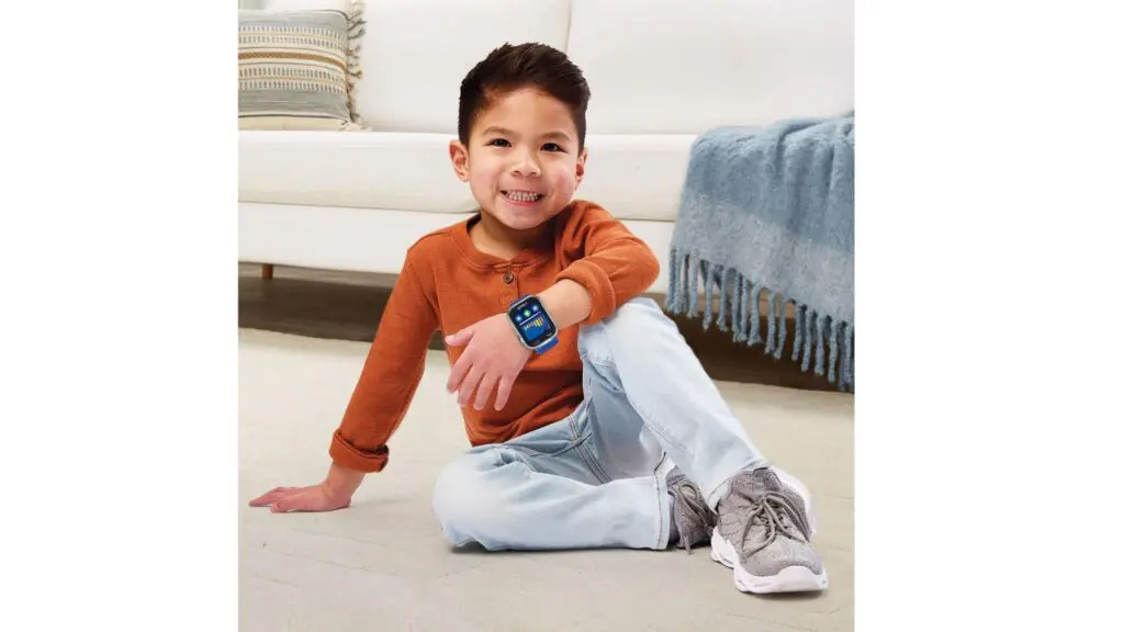 A little boy wearing a VTech KidiZoom Smartwatch DX4