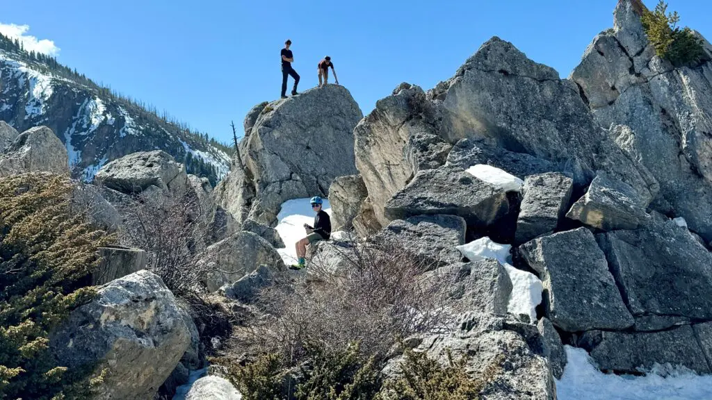 Teenagers climbing and standing on rocks at Yellowstone National Park