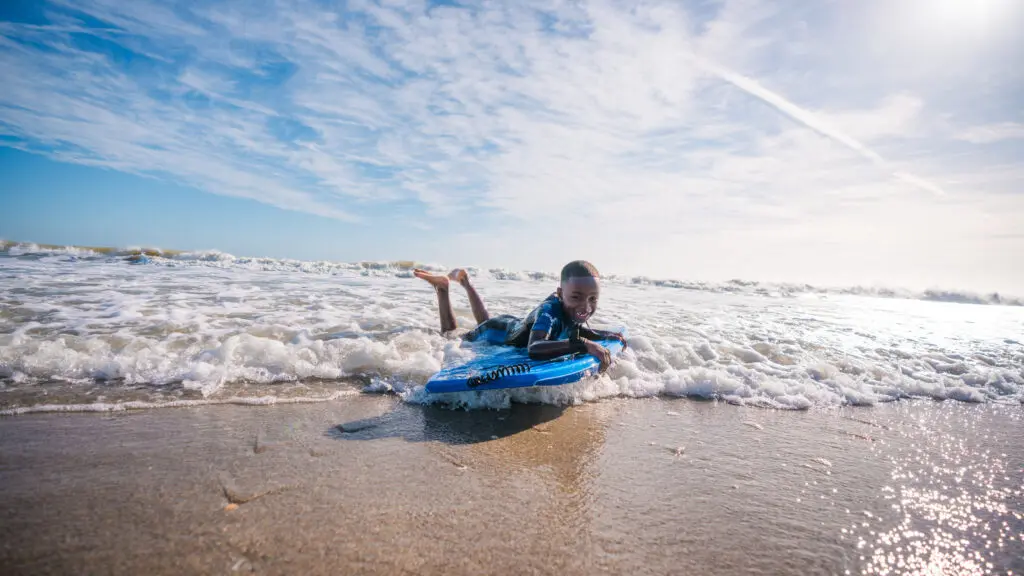 A boy bodyboarding in Cocoa Beach