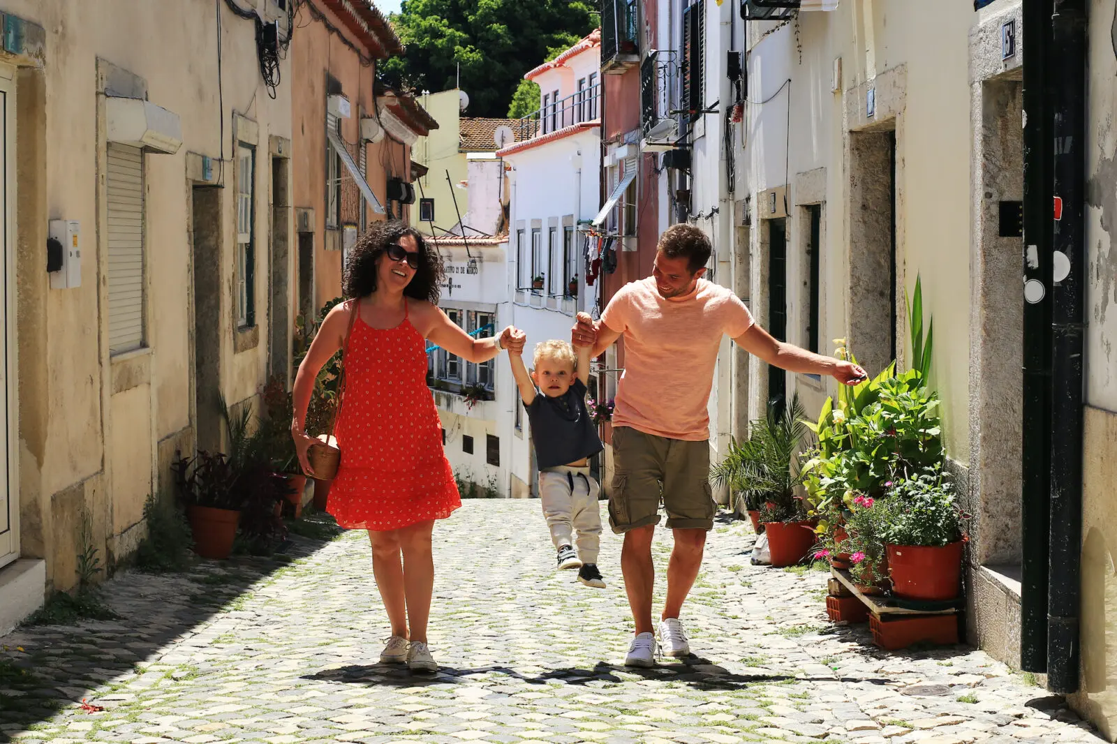 A family with a baby on vacation in Lisbon Portugal in the old town