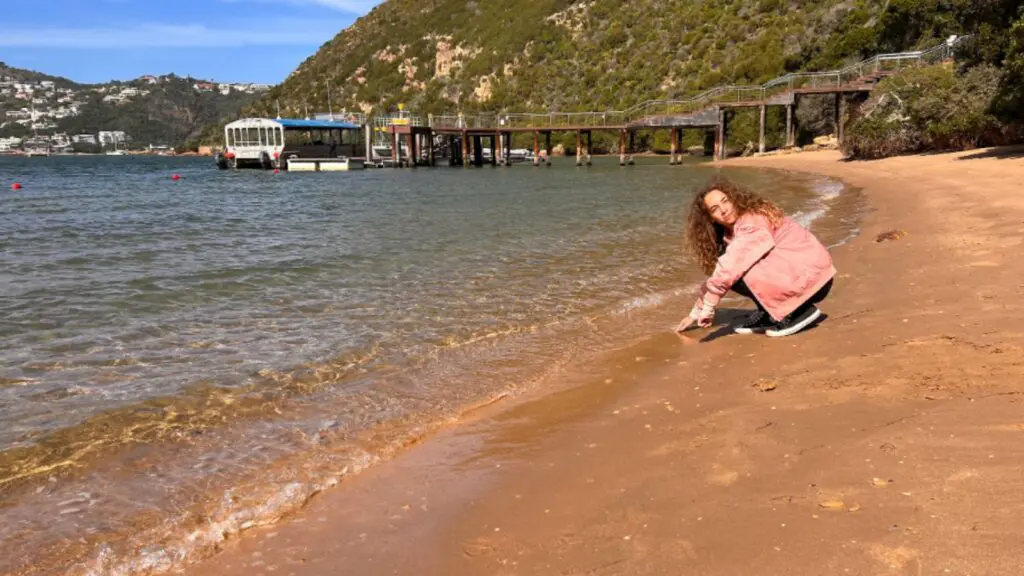 Child touching the Indian Ocean on a vacation