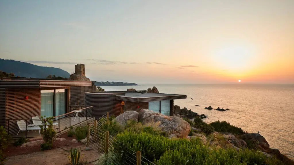 sunset along cliff with Club Med Cefalù, Sicily resort perched on the shore