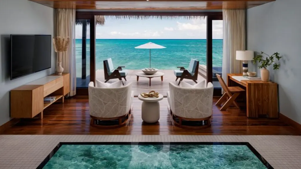The interior of an overwater private villa looking out onto the ocean at Sandals Royal Caribbean