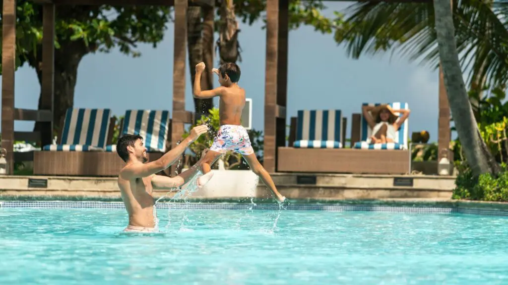 Family playing in pool