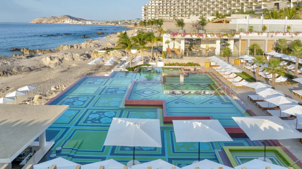 The beach and pool with lots of white umbrellas at Grand Velas Boutique Los Cabos