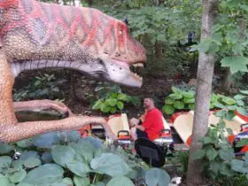 Passengers on boats encounter dinosaurs at the Columbus Zoo and Aquarium. Photo by Tim Trudell