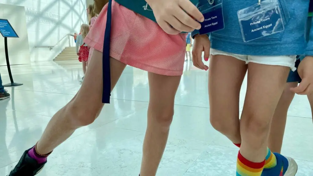 kids legs with visible British Museum out of hours tour passes hanging