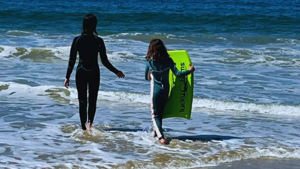kids playing in the ocean at the beach at Waldorf Astoria Monarch Beach