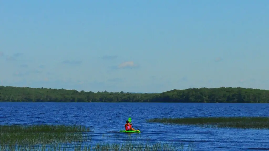 A person kayaking on Worden Pond in Rhode Island