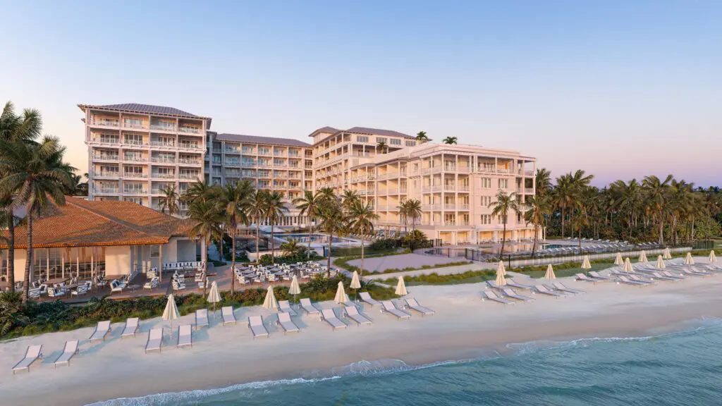 A view from the water of the beach and the exterior of Naples Beach Club, A Four Seasons Resort