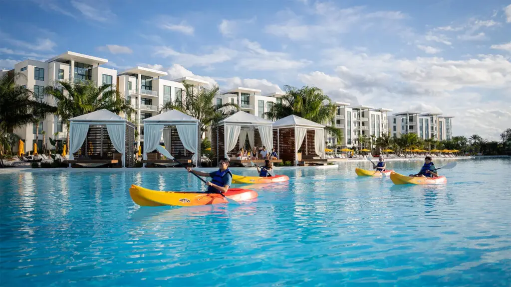 Kayakers gliding past cabanas