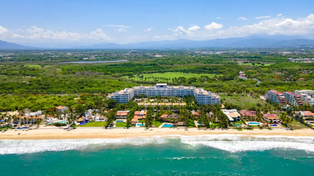 An aerial view of Marival Distinct All-Suites & World Spa and its beach area